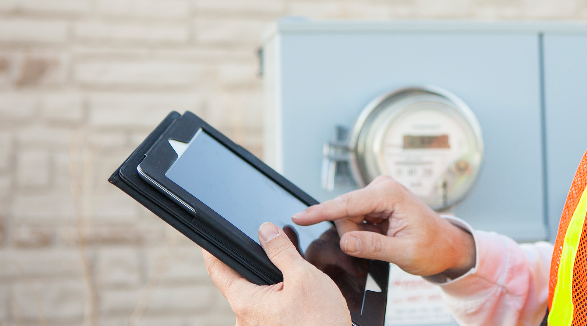 © istock.com/powerofforever Ein Techniker mit Tablet in der Hand prüft Zählerstände.